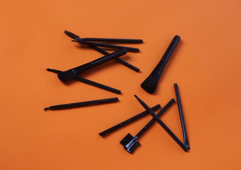 Hamster Accessories - a group of black pens sitting on top of an orange surface