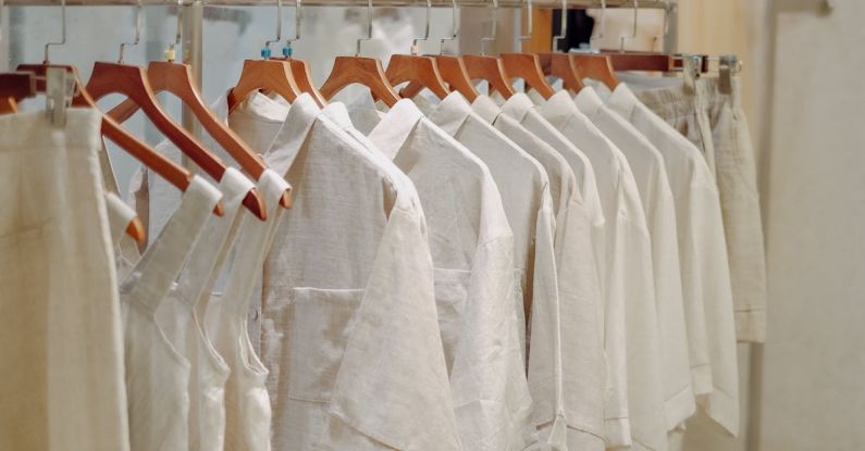 Hamster Basics - Clothes in Neutral Colors Hanging on the Racks in a Clothing Store