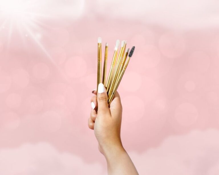 Hamster Accessories - person holding brown sticks on pink background