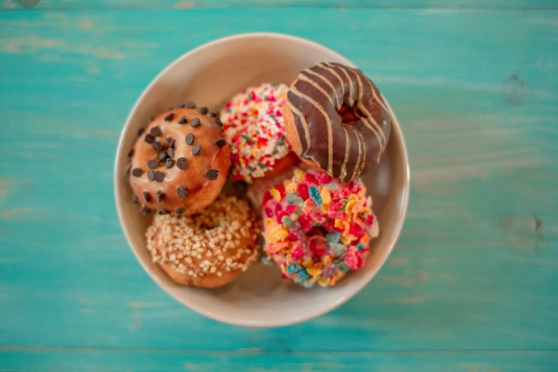 Hamster Food - seven assorted-flavor doughnuts on brown ceramic bowl