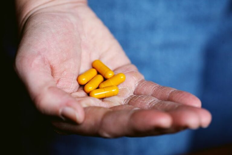 Hamster Supplements - yellow medication pill on persons hand