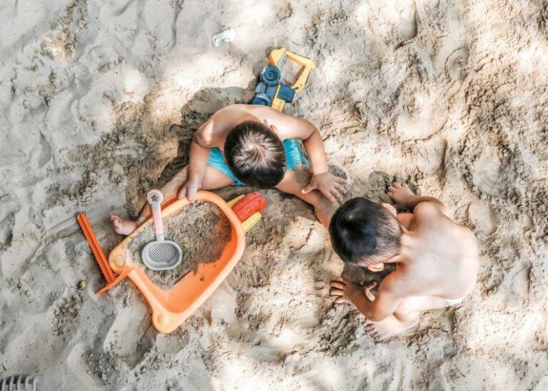 Hamster Toys - 2 boys sitting on sand